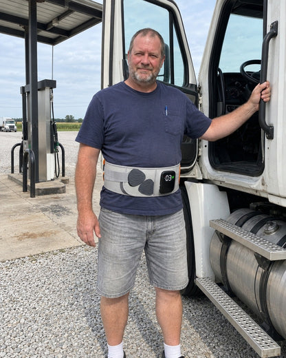 Driver wearing the Celinva back support belt beside his truck